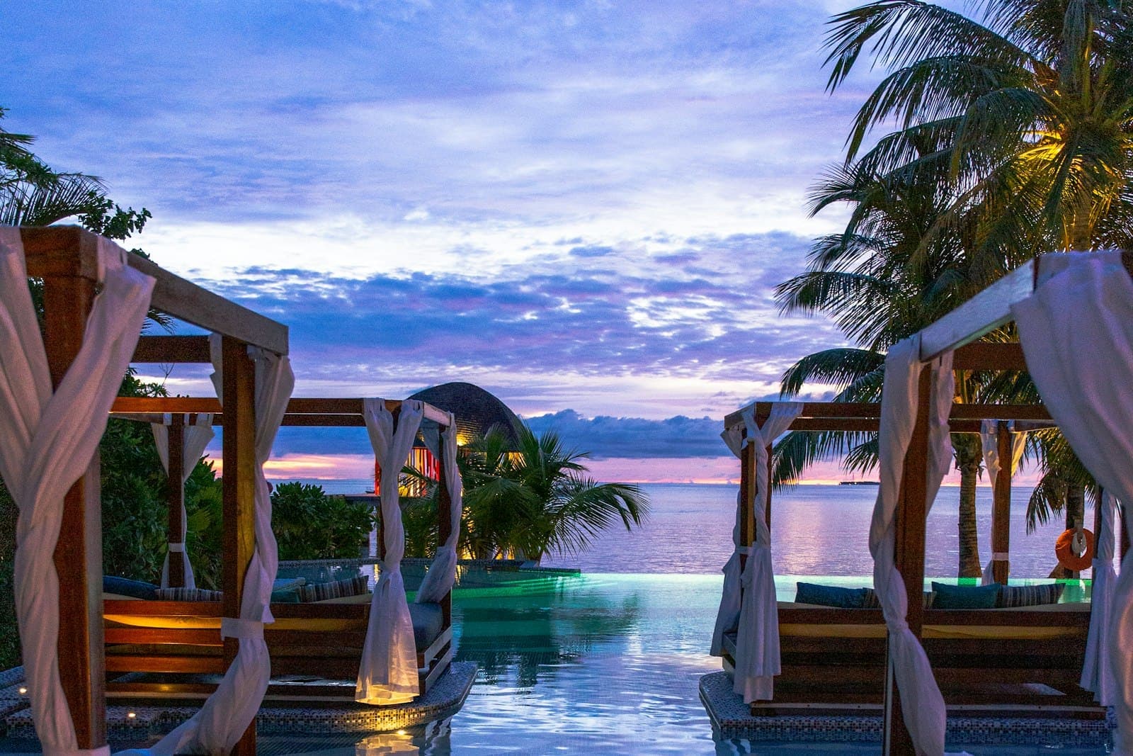The infinity pool at dusk at Zambezi Reach, Victoria Falls, looking upstream over the river